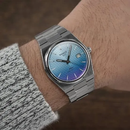 Tissot PRX light blue-purple gradient dial on wrist, seamless bracelet integration shown