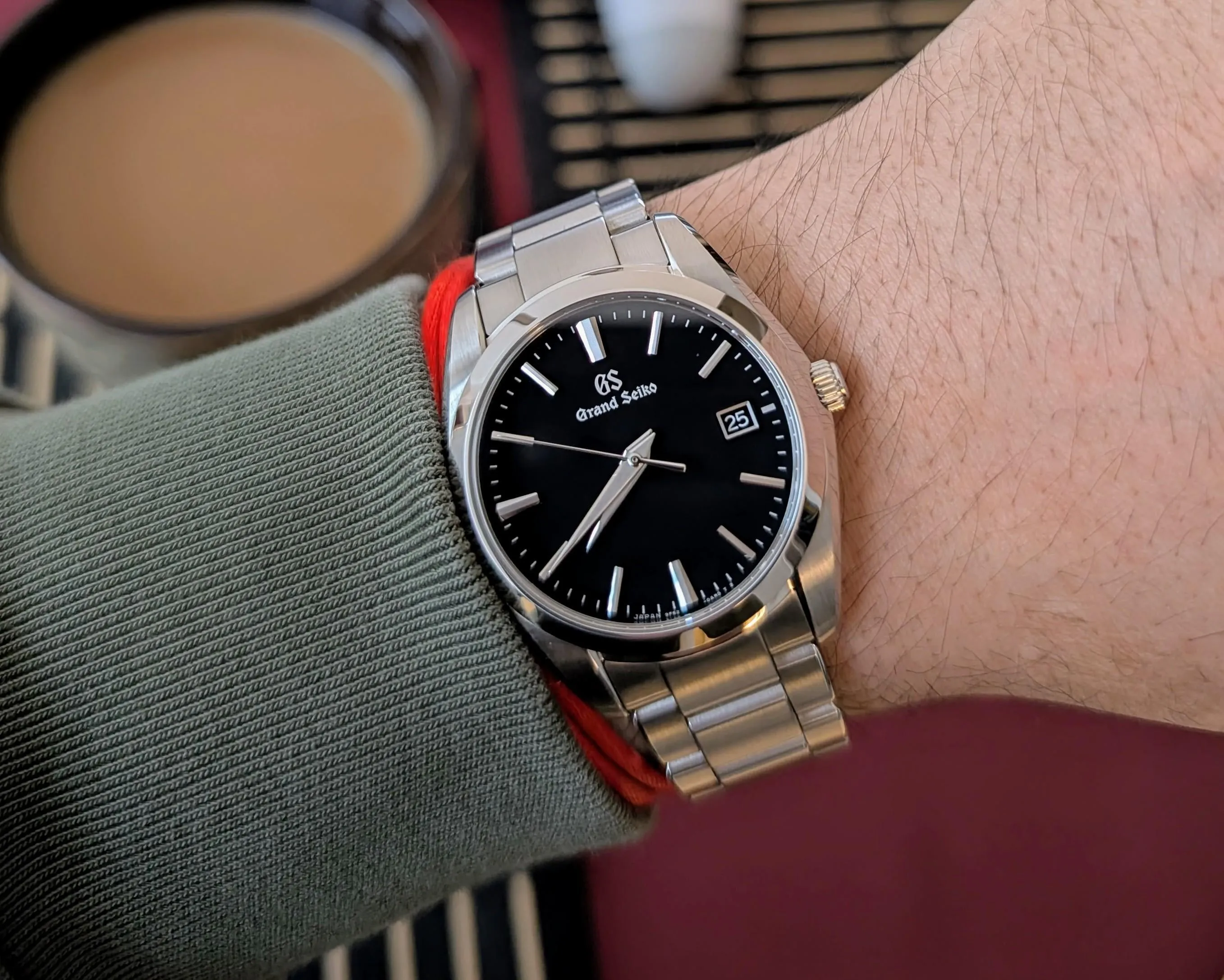 Grand Seiko SBGX261 on wrist, black dial with bright index reflections