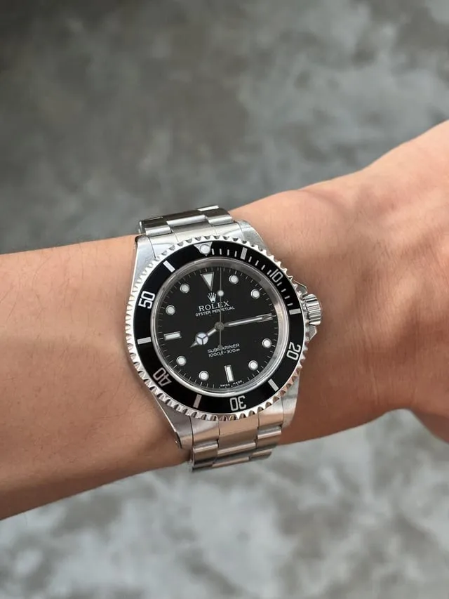 Modern Rolex Submariner no-date on wrist with black ceramic bezel and Oyster bracelet