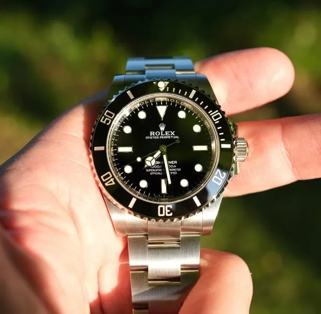 Modern Rolex Submariner 124060 no-date with black ceramic bezel held in hand